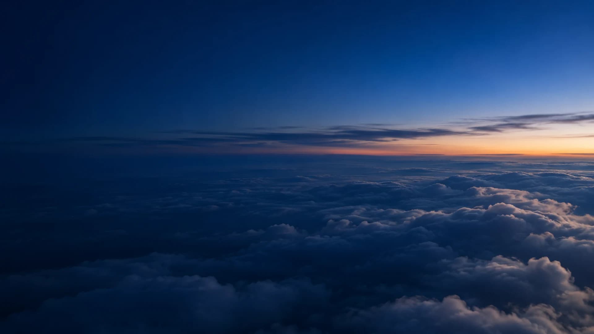 Clouds below a deep blue evening sky