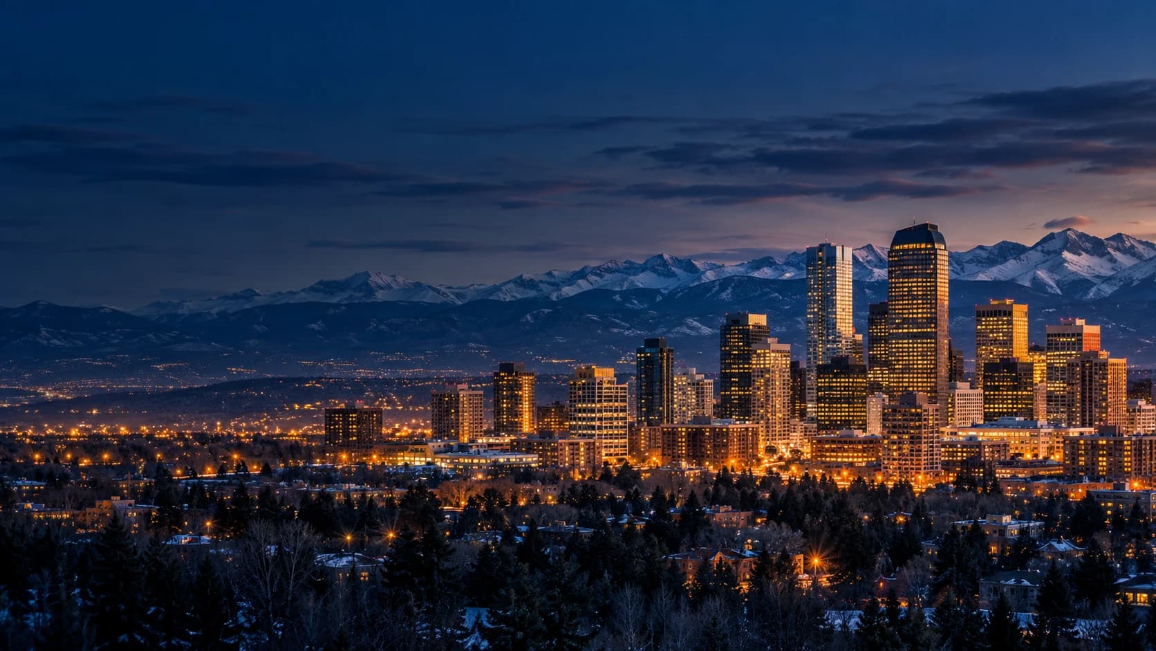 Denver skyline and the Rocky Mountains at blue hour