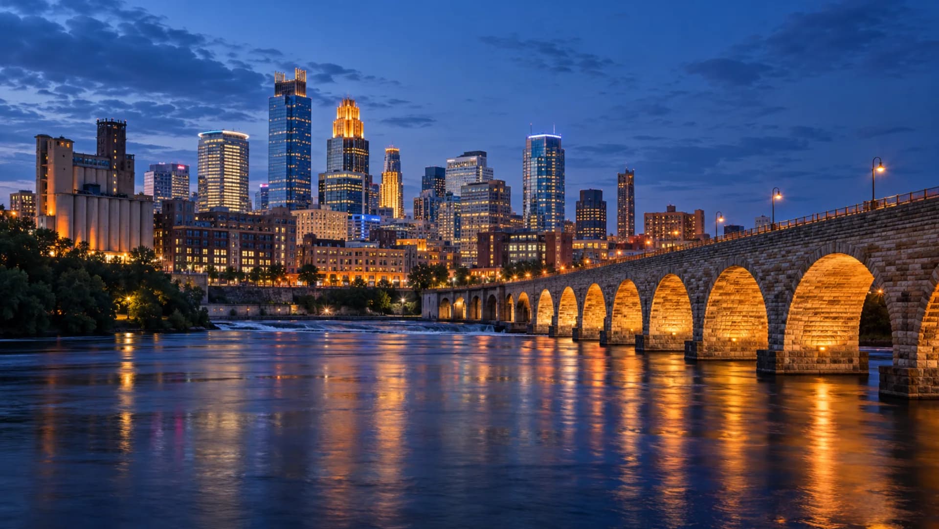 Minneapolis skyline and Stone Arch Bridge at blue hour