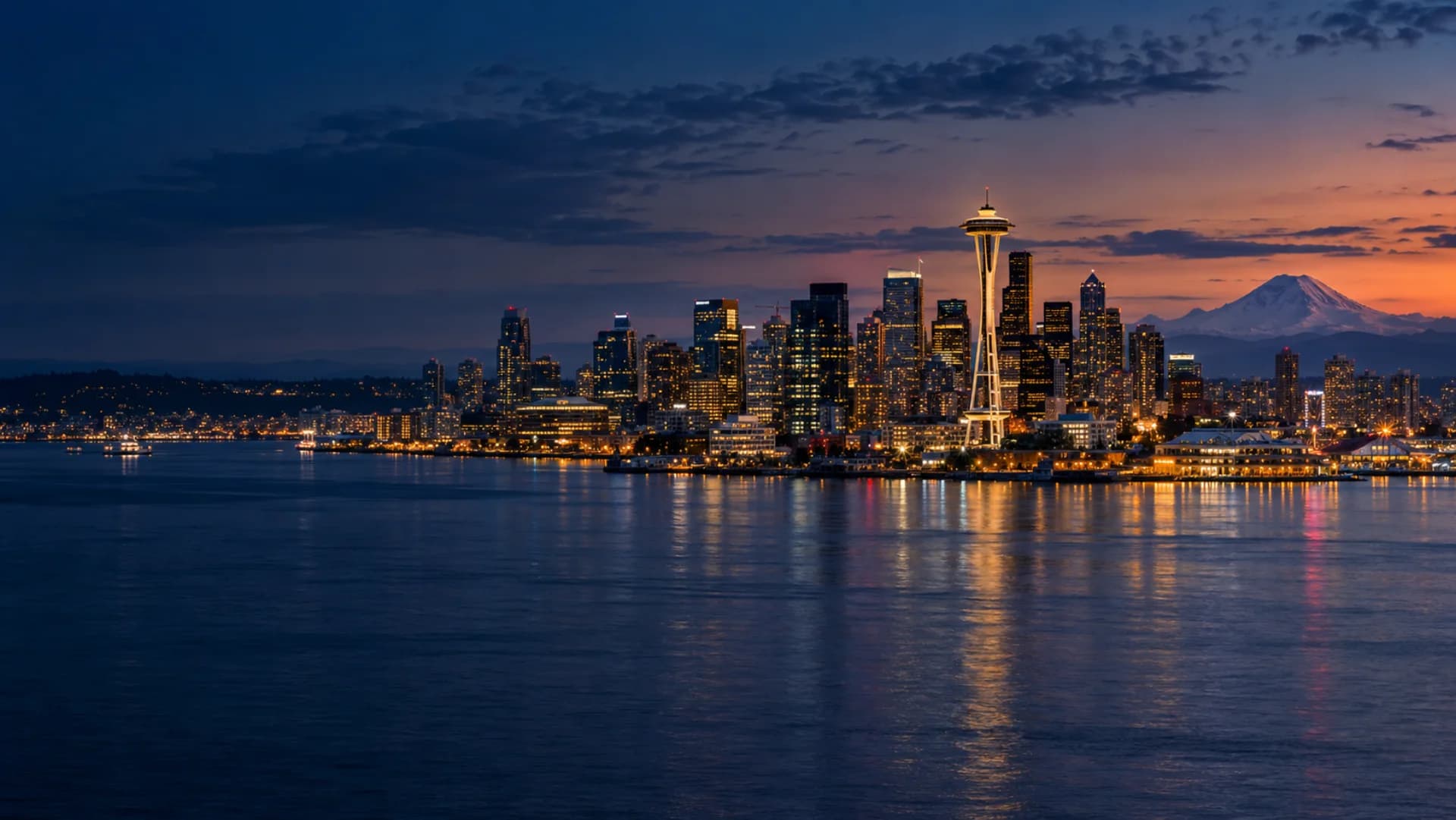 Seattle skyline, Elliott Bay and Mount Rainier at blue hour