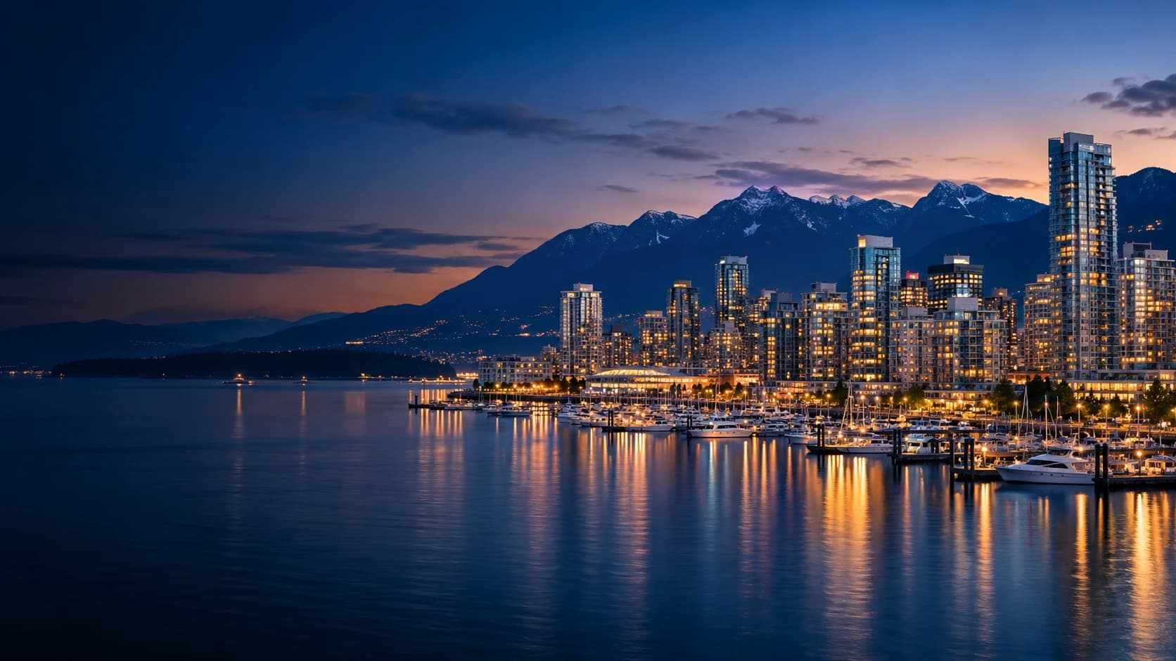 Vancouver harbour, skyline and mountains at blue hour