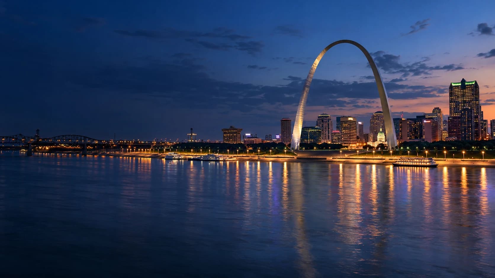 St. Louis skyline and Gateway Arch beside the Mississippi at blue hour